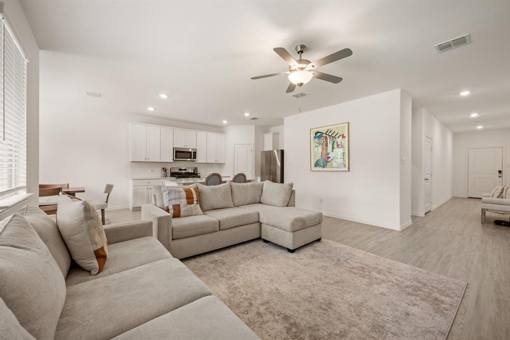 3200 Willow Terrace Lane Anna, TX 75409 - Photo 14 of 40 a living room with furniture and a chandelier