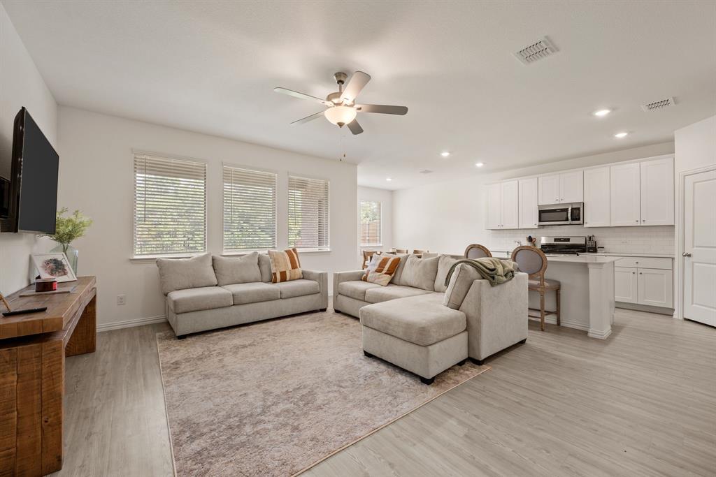 3200 Willow Terrace Lane Anna, TX 75409 - Photo 2 of 40 a living room with furniture a ceiling fan and a flat screen tv
