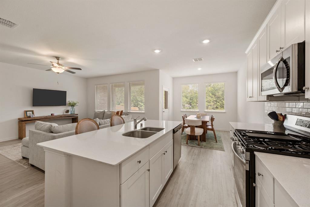 3200 Willow Terrace Lane Anna, TX 75409 - Photo 4 of 40 a kitchen with sink refrigerator and stove
