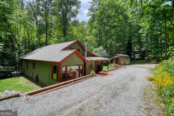 a backyard of a house with wooden fence and trees