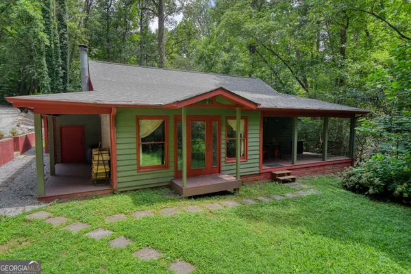 a front view of a house with a fountain