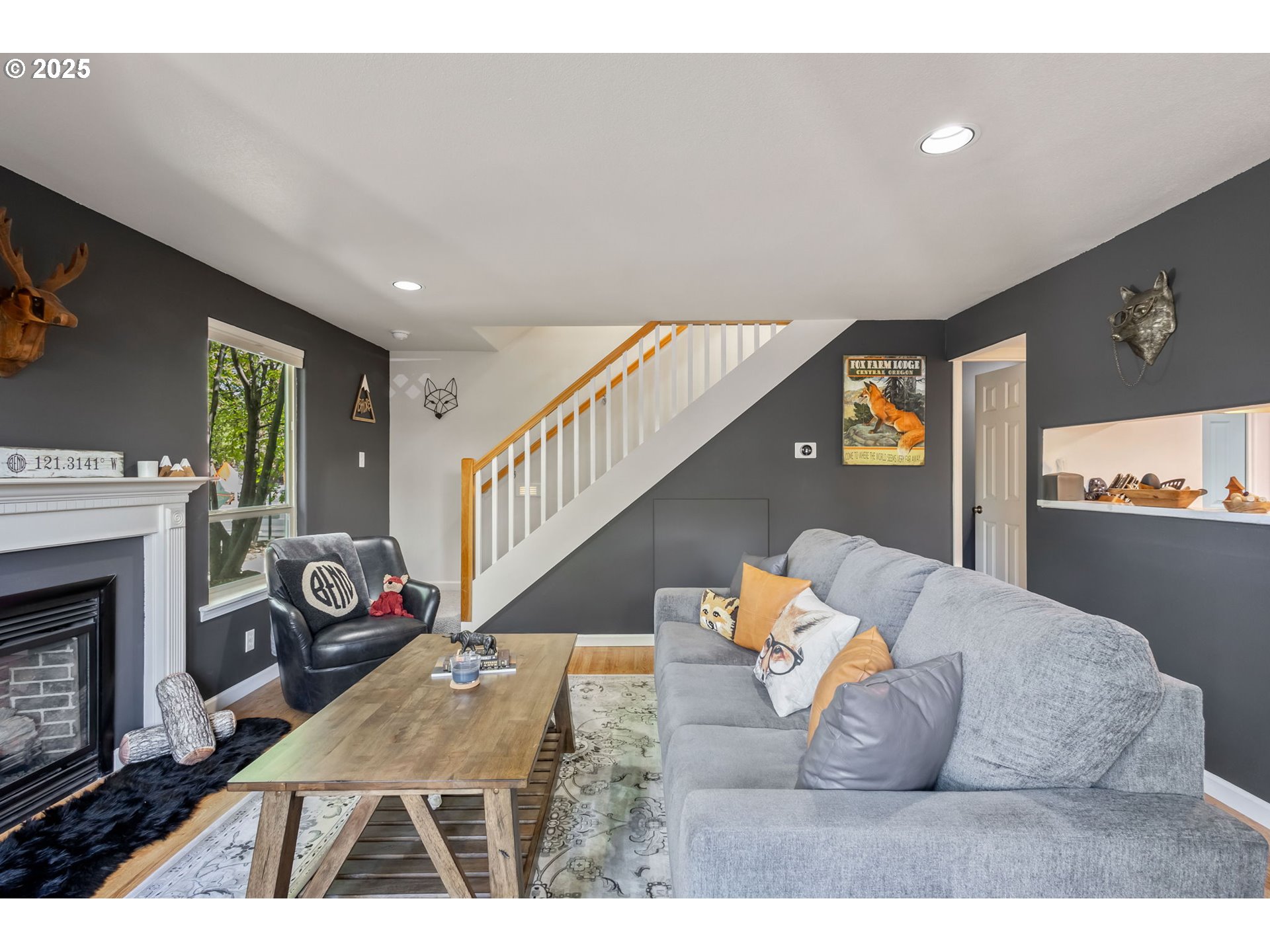 111 Northwest Hawthorne Avenue, Unit 1 Bend, OR 97703 - Photo 11 of 31 a living room with furniture a fireplace and a flat screen tv