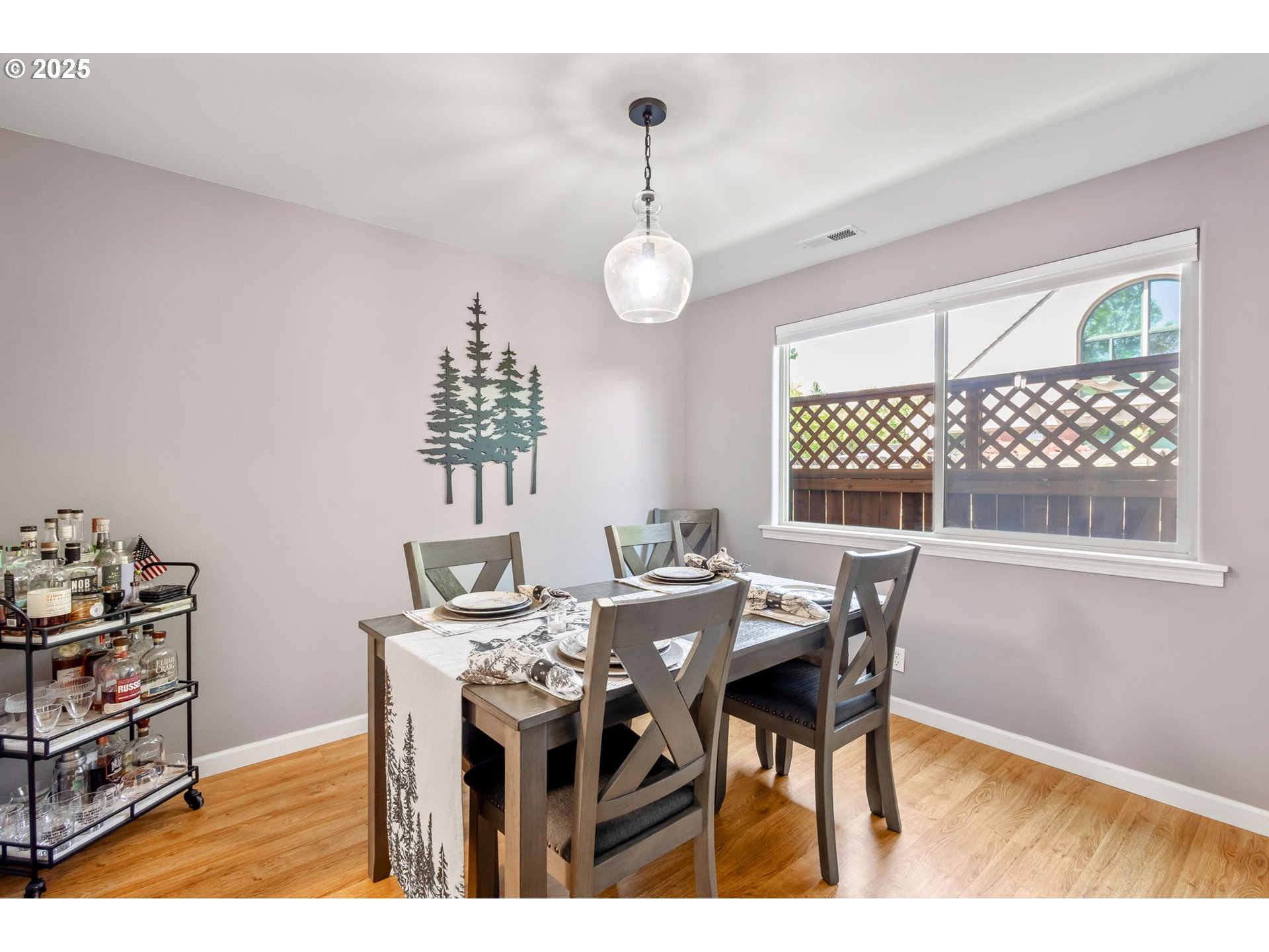 111 Northwest Hawthorne Avenue, Unit 1 Bend, OR 97703 - Photo 13 of 31 a view of a dining room with furniture window and wooden floor