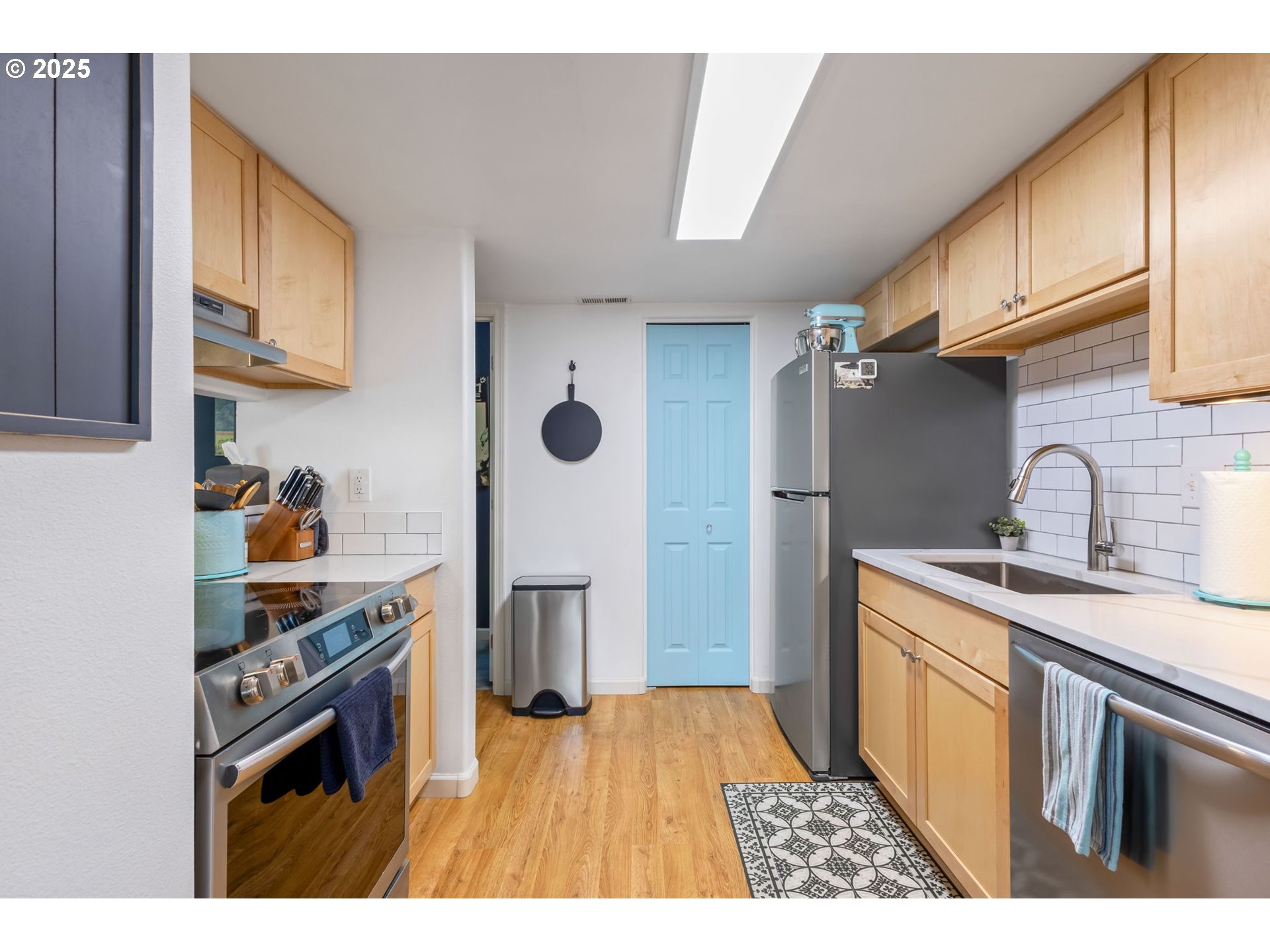 111 Northwest Hawthorne Avenue, Unit 1 Bend, OR 97703 - Photo 15 of 31 a kitchen with stainless steel appliances granite countertop a stove a sink dishwasher a refrigerator and cabinets with wooden floor