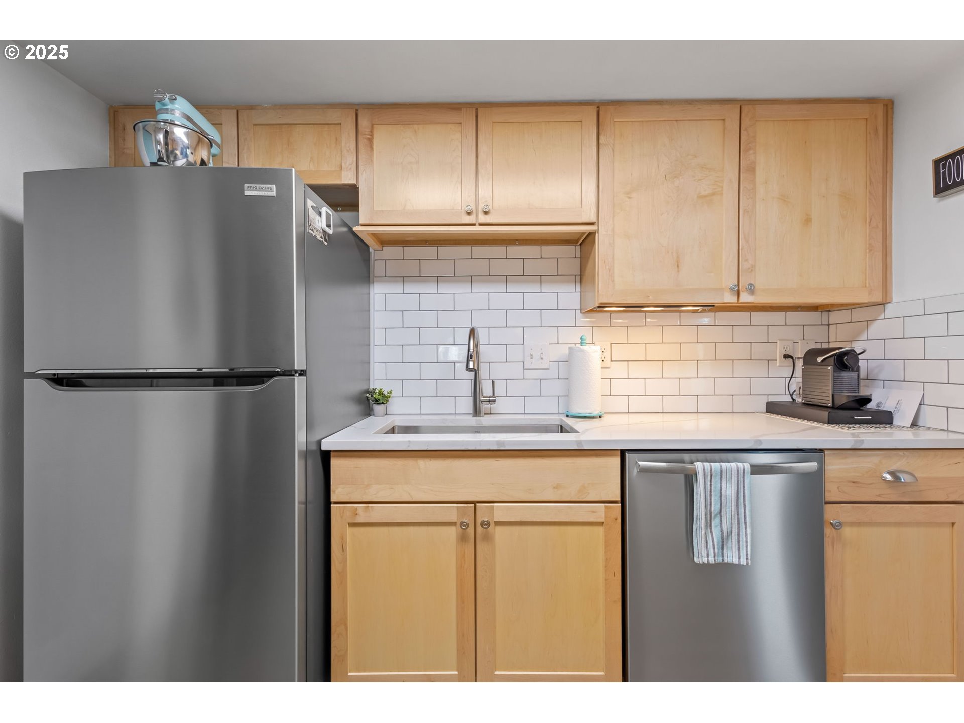 111 Northwest Hawthorne Avenue, Unit 1 Bend, OR 97703 - Photo 18 of 31 a kitchen with stainless steel appliances granite countertop a refrigerator a sink and white cabinets