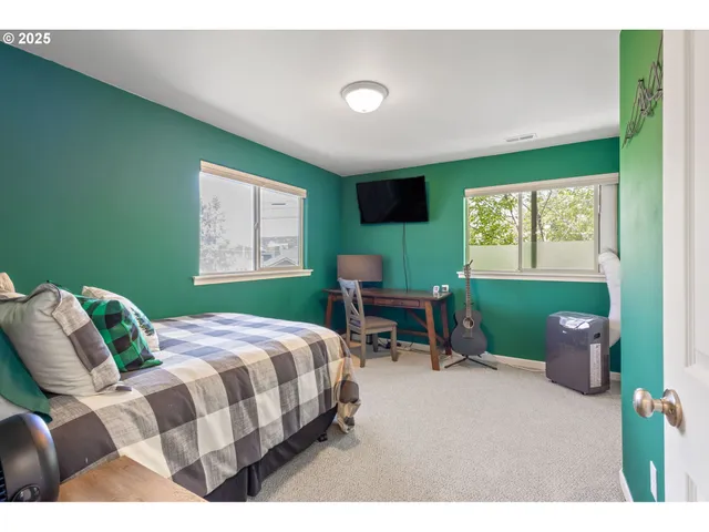 a bedroom with a bed chair and window