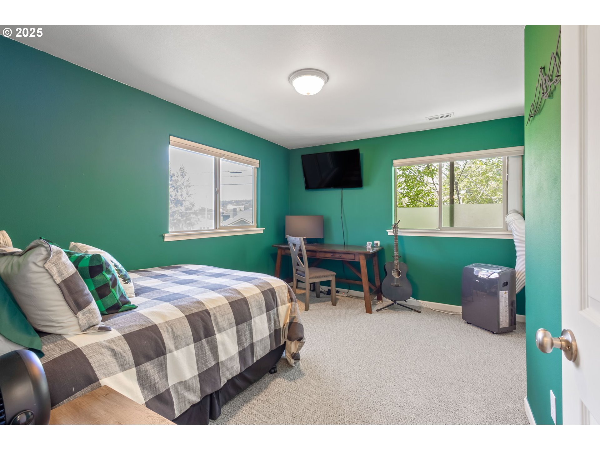 111 Northwest Hawthorne Avenue, Unit 1 Bend, OR 97703 - Photo 20 of 31 a bedroom with a bed chair and window