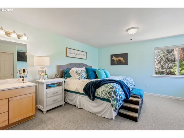 a bedroom with a bed and a painting on the wall