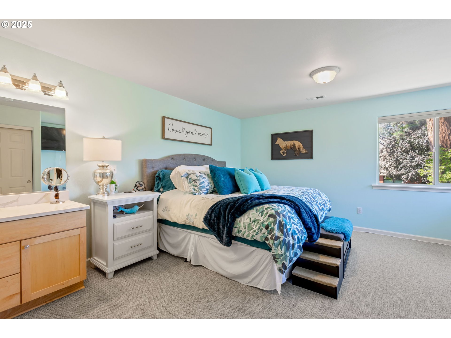 111 Northwest Hawthorne Avenue, Unit 1 Bend, OR 97703 - Photo 22 of 31 a bedroom with a bed and a painting on the wall