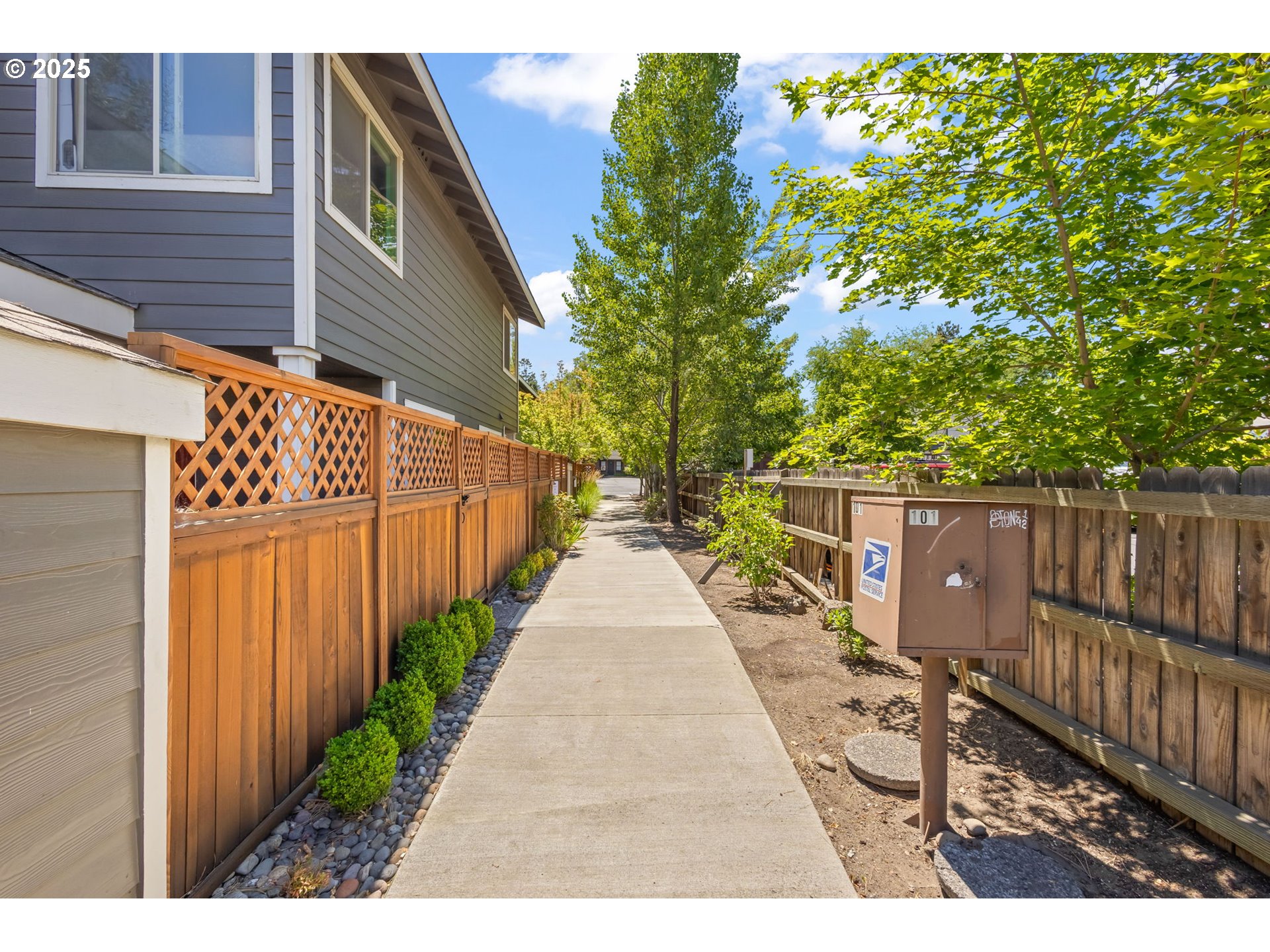 111 Northwest Hawthorne Avenue, Unit 1 Bend, OR 97703 - Photo 3 of 31 a view of a pathway with a wrought fence