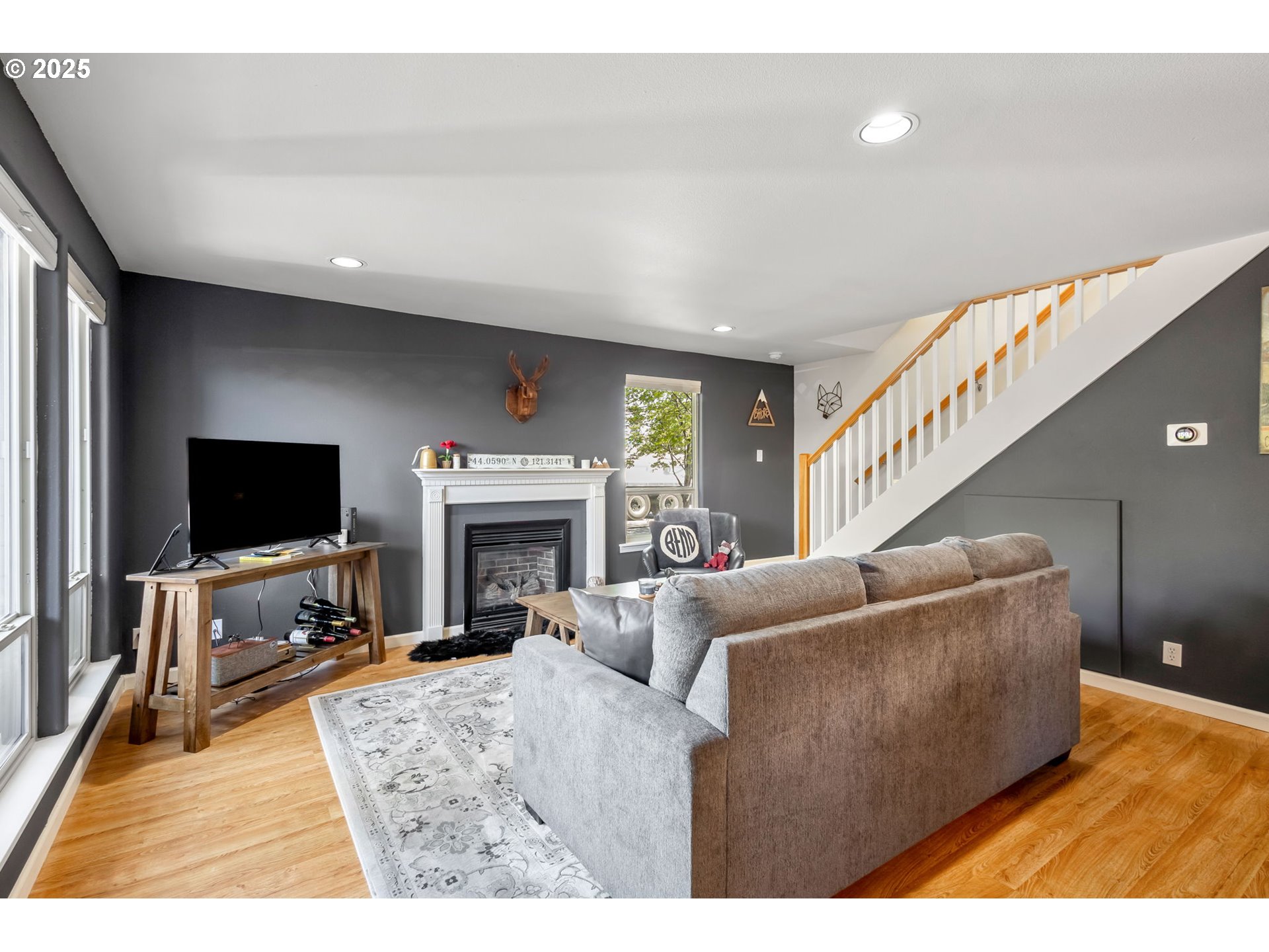 111 Northwest Hawthorne Avenue, Unit 1 Bend, OR 97703 - Photo 8 of 31 a living room with furniture a flat screen tv and a fireplace