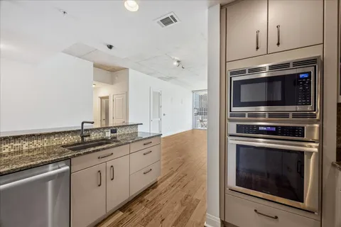a kitchen with stainless steel appliances granite countertop a stove and a sink