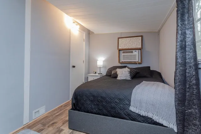 a bedroom with a bed and a window