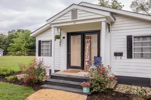 a front view of a house with a garden
