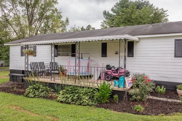 a front view of house with yard and outdoor seating