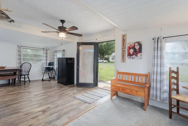 a living room with furniture and a ceiling fan