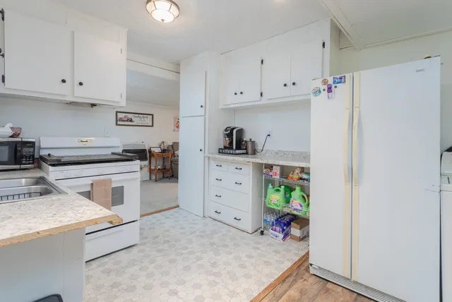 a kitchen with cabinets appliances and a counter space