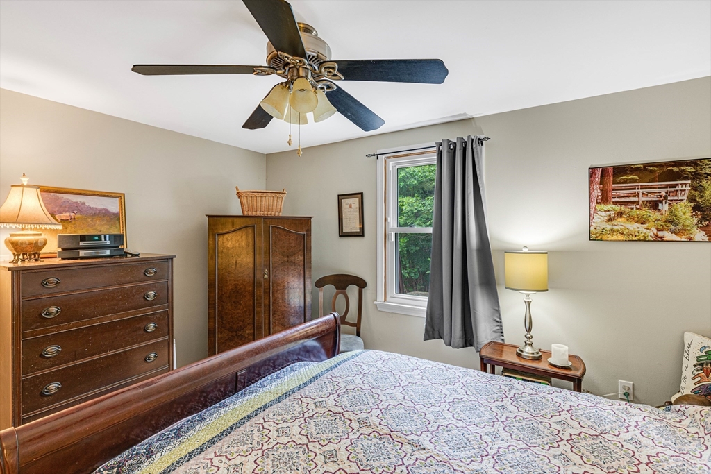 15 Lawrence Road, Unit 23 Rowley, MA 01969 - Photo 11 of 16 a bedroom with a bed and wooden floor