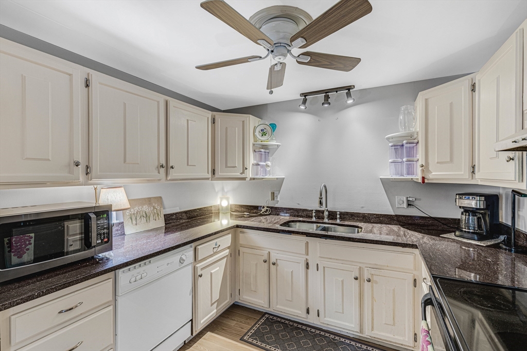 15 Lawrence Road, Unit 23 Rowley, MA 01969 - Photo 3 of 16 a kitchen with stainless steel appliances granite countertop a sink a stove and cabinets