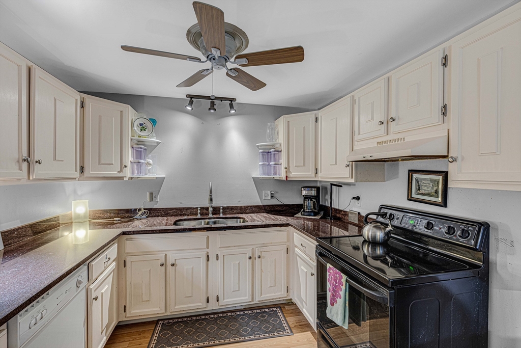 15 Lawrence Road, Unit 23 Rowley, MA 01969 - Photo 4 of 16 a kitchen with stainless steel appliances a sink a stove and cabinets