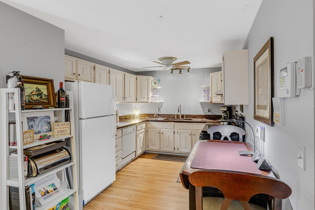 15 Lawrence Road, Unit 23 Rowley, MA 01969 - Photo 5 of 16 a kitchen with a refrigerator and a stove top oven