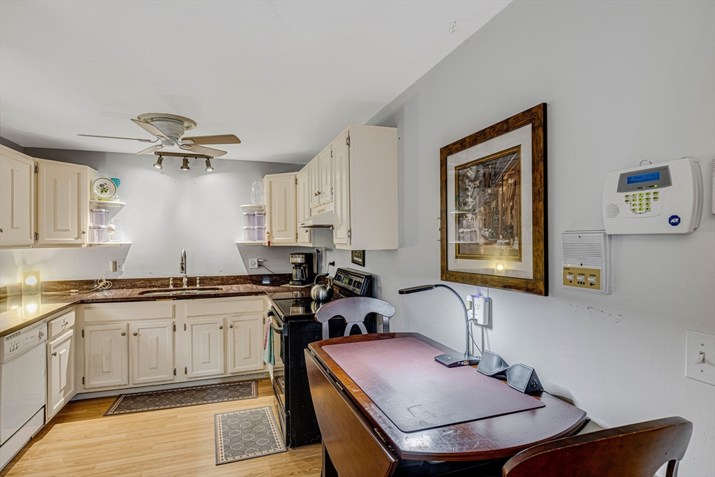 15 Lawrence Road, Unit 23 Rowley, MA 01969 - Photo 6 of 16 a kitchen with a sink stove and cabinets