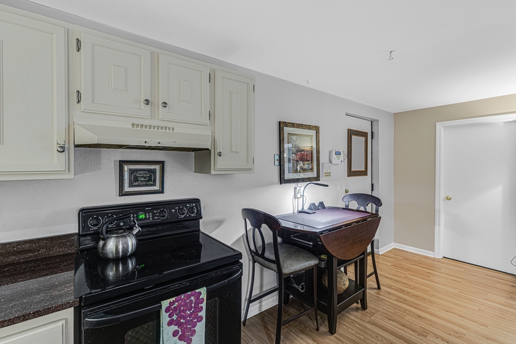 15 Lawrence Road, Unit 23 Rowley, MA 01969 - Photo 7 of 16 a kitchen with a table chairs and a stove