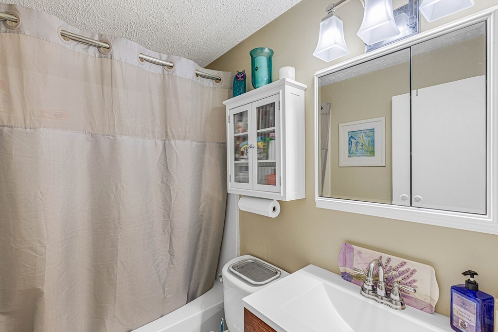 15 Lawrence Road, Unit 23 Rowley, MA 01969 - Photo 8 of 16 a bathroom with a sink and a mirror