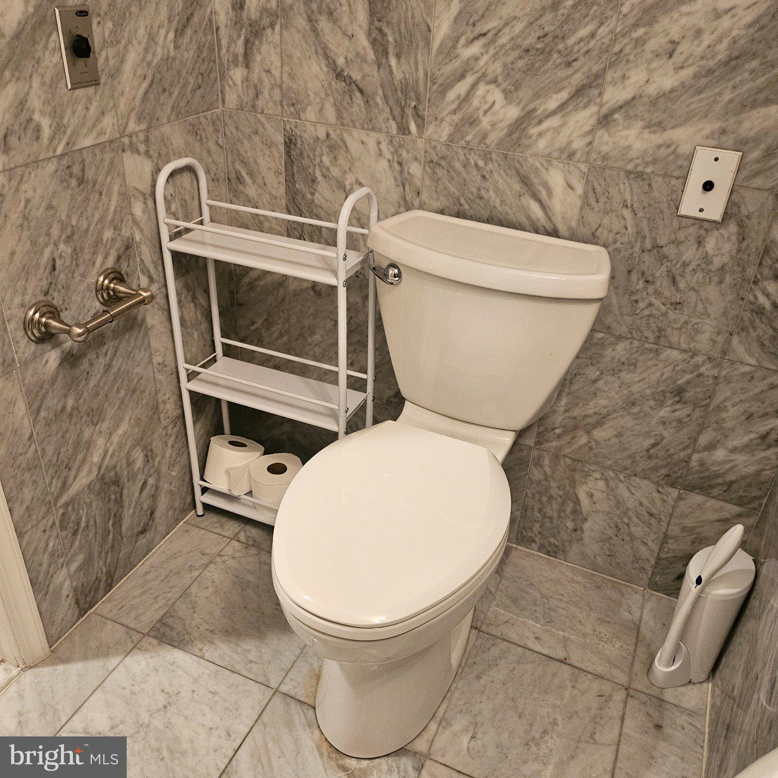 3801 Canterbury Road, Unit 611 Baltimore, MD 21218 - Photo 11 of 32 a white toilet sitting next to a shower