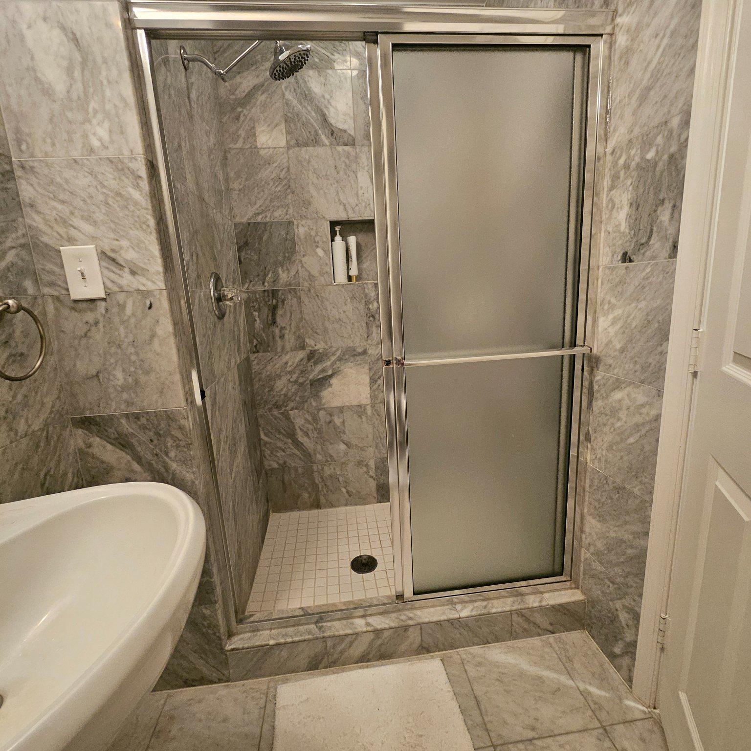 3801 Canterbury Road, Unit 611 Baltimore, MD 21218 - Photo 13 of 32 a bathroom with a bathtub and a shower