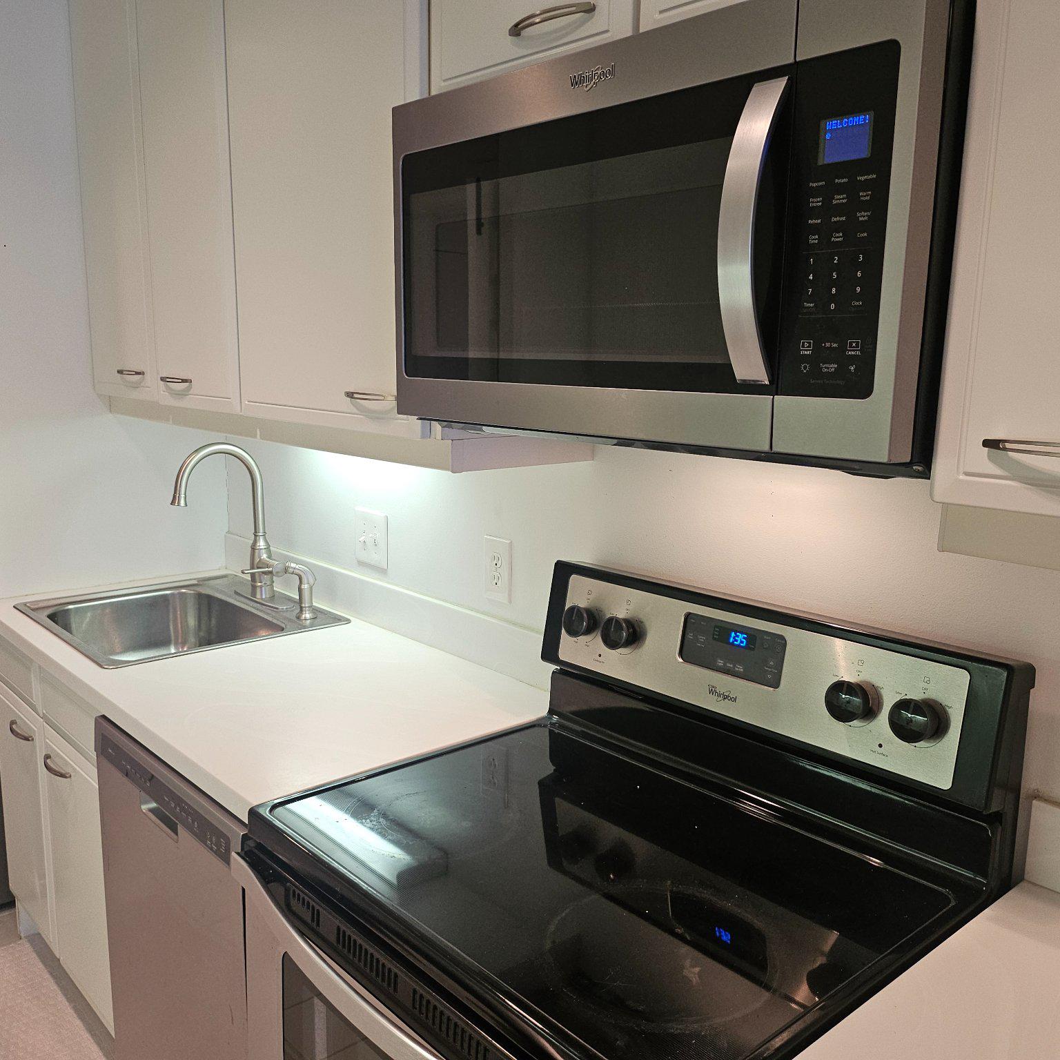 3801 Canterbury Road, Unit 611 Baltimore, MD 21218 - Photo 17 of 32 a kitchen with a stove and a microwave