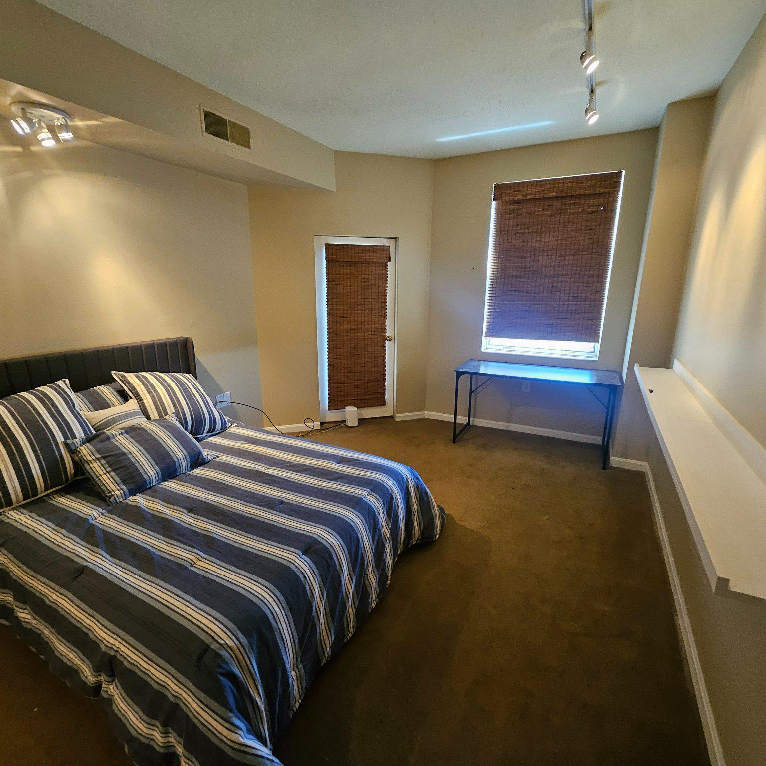 3801 Canterbury Road, Unit 611 Baltimore, MD 21218 - Photo 9 of 32 a bedroom with a bed and wooden floor