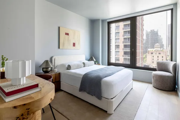 a bedroom with bed and window