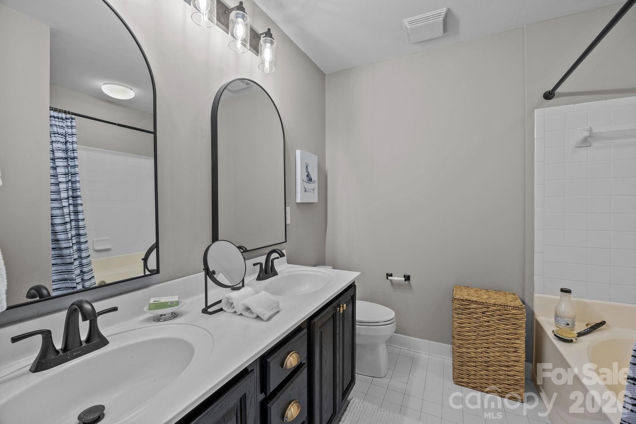 416 Queens Road, Unit 19 Charlotte, NC 28207 - Photo 12 of 23 a bathroom with a sink and a mirror