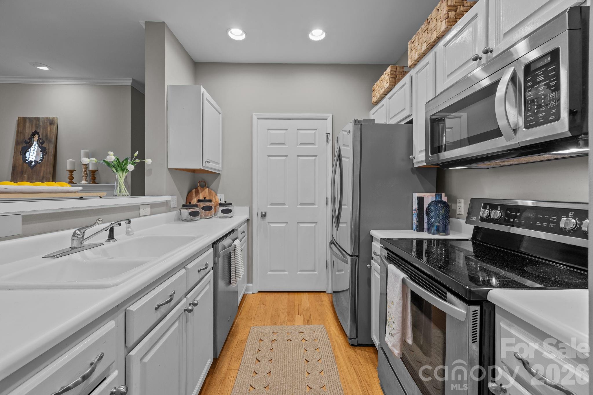 416 Queens Road, Unit 19 Charlotte, NC 28207 - Photo 2 of 24 a kitchen with stainless steel appliances granite countertop a stove and a refrigerator