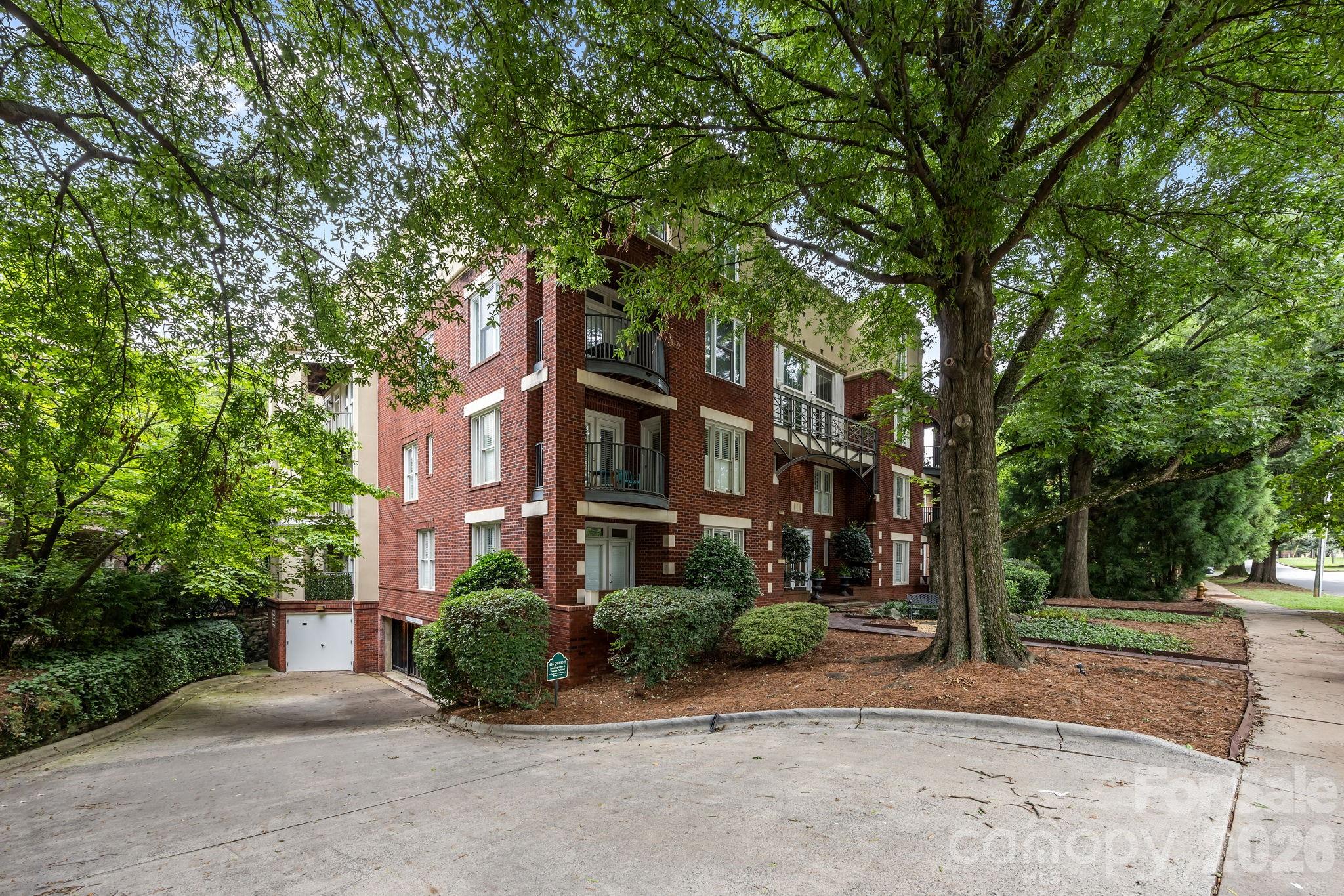 416 Queens Road, Unit 19 Charlotte, NC 28207 - Photo 22 of 24 a front view of a building with a yard