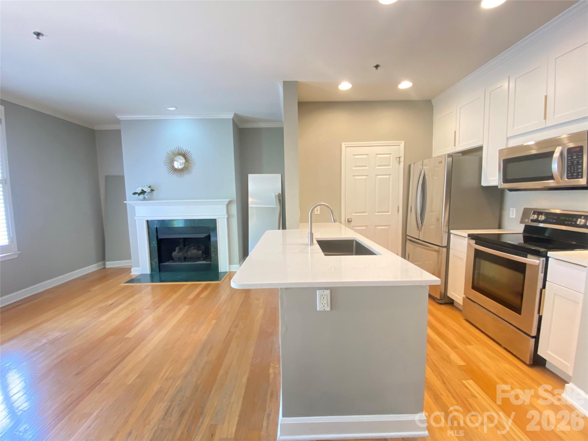416 Queens Road, Unit 19 Charlotte, NC 28207 - Photo 3 of 23 a view of kitchen stove microwave and cabinets