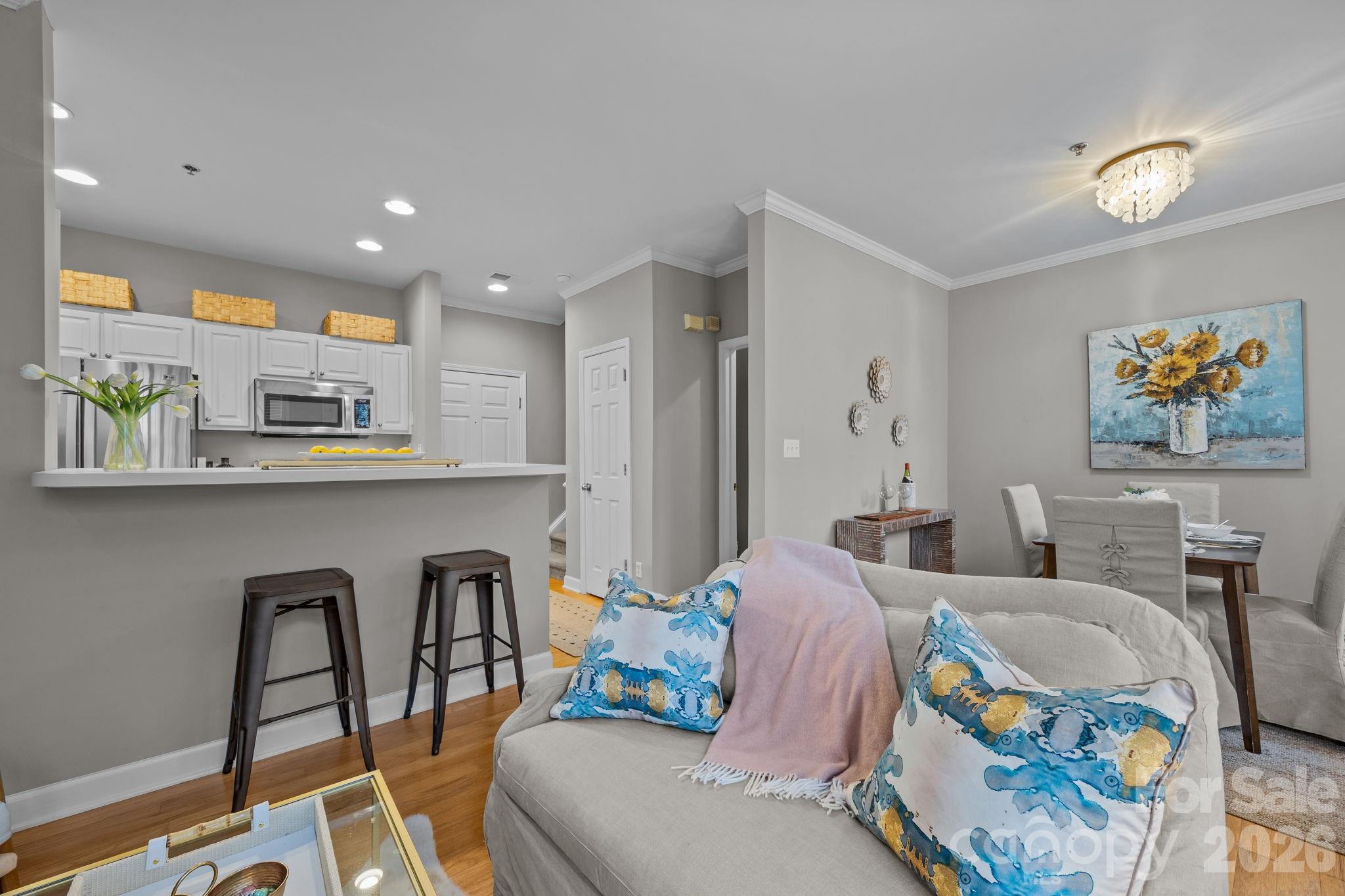 416 Queens Road, Unit 19 Charlotte, NC 28207 - Photo 5 of 24 a living room with furniture and kitchen view