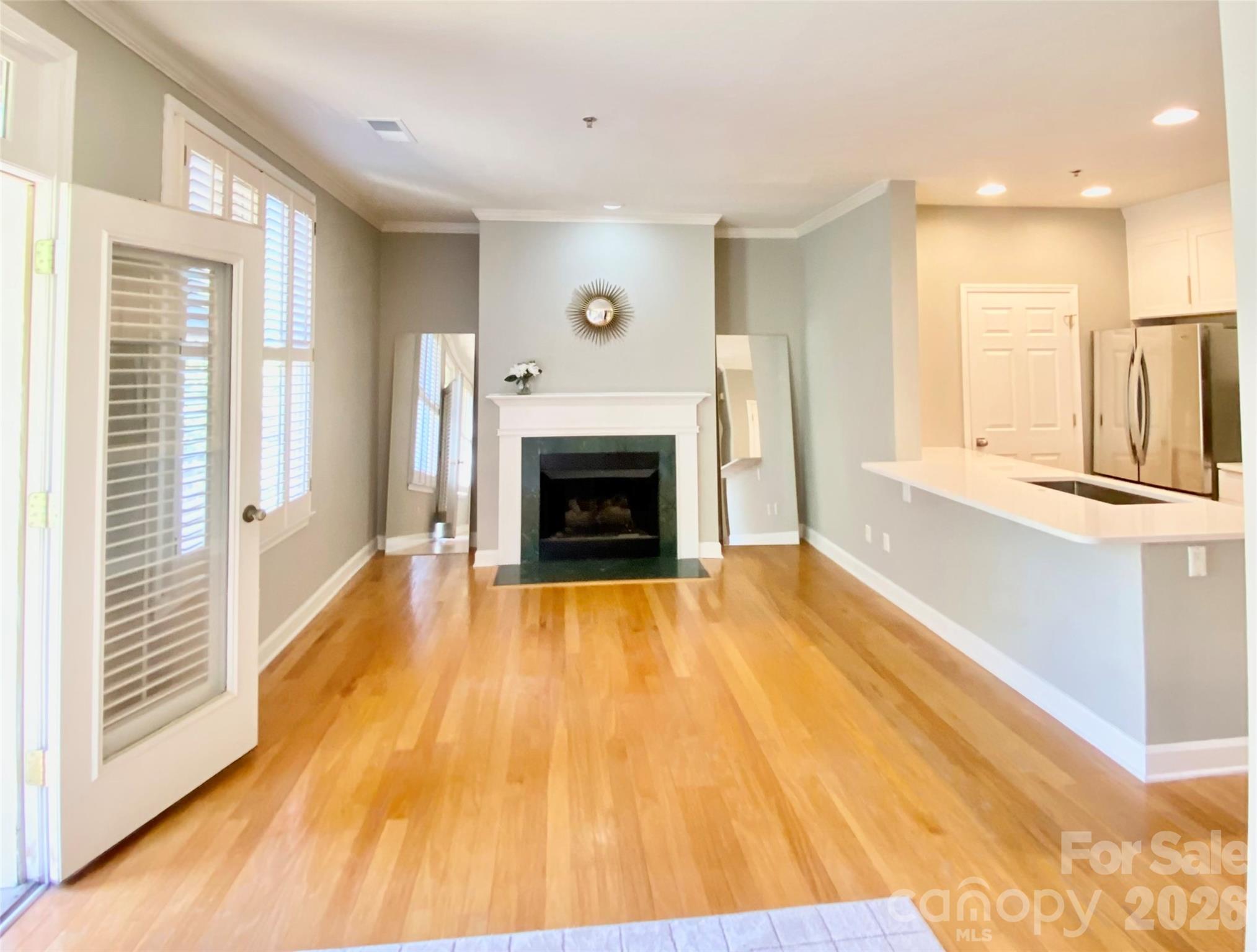416 Queens Road, Unit 19 Charlotte, NC 28207 - Photo 7 of 23 a view of a livingroom with wooden floor