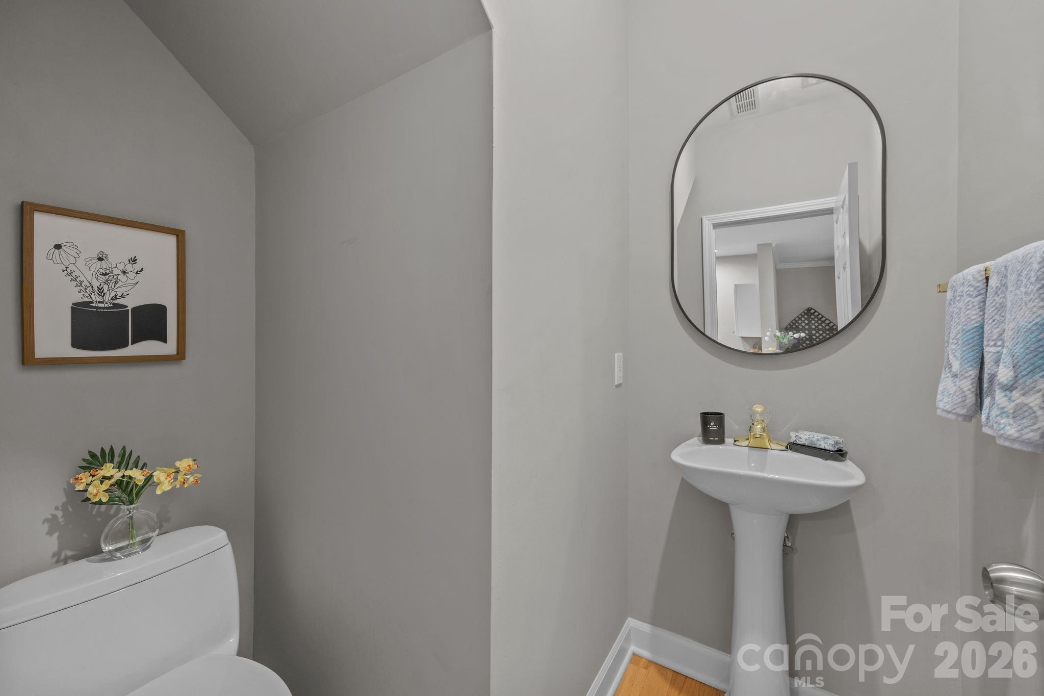 416 Queens Road, Unit 19 Charlotte, NC 28207 - Photo 8 of 23 a bathroom with a toilet a sink and a mirror