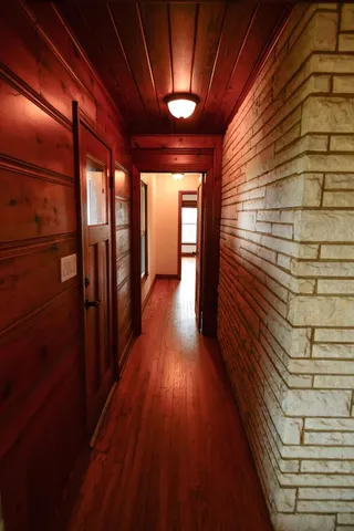 an empty room with wooden floor and a fireplace