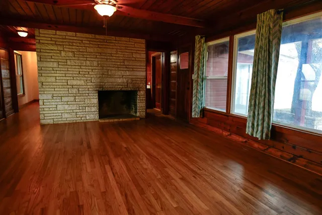 a view of door with wooden floor and windows