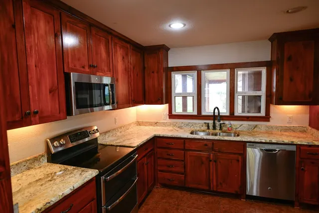 a living room with fireplace furniture and a chandelier