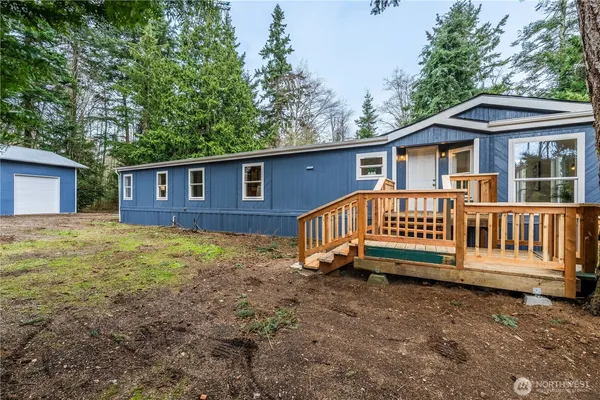 a view of a house with a yard and deck