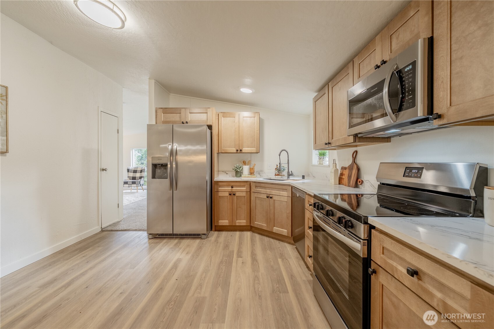 10794 Halloran Road Bow, WA 98232 - Photo 12 of 39 a kitchen with stainless steel appliances granite countertop a refrigerator a stove top oven a sink and dishwasher