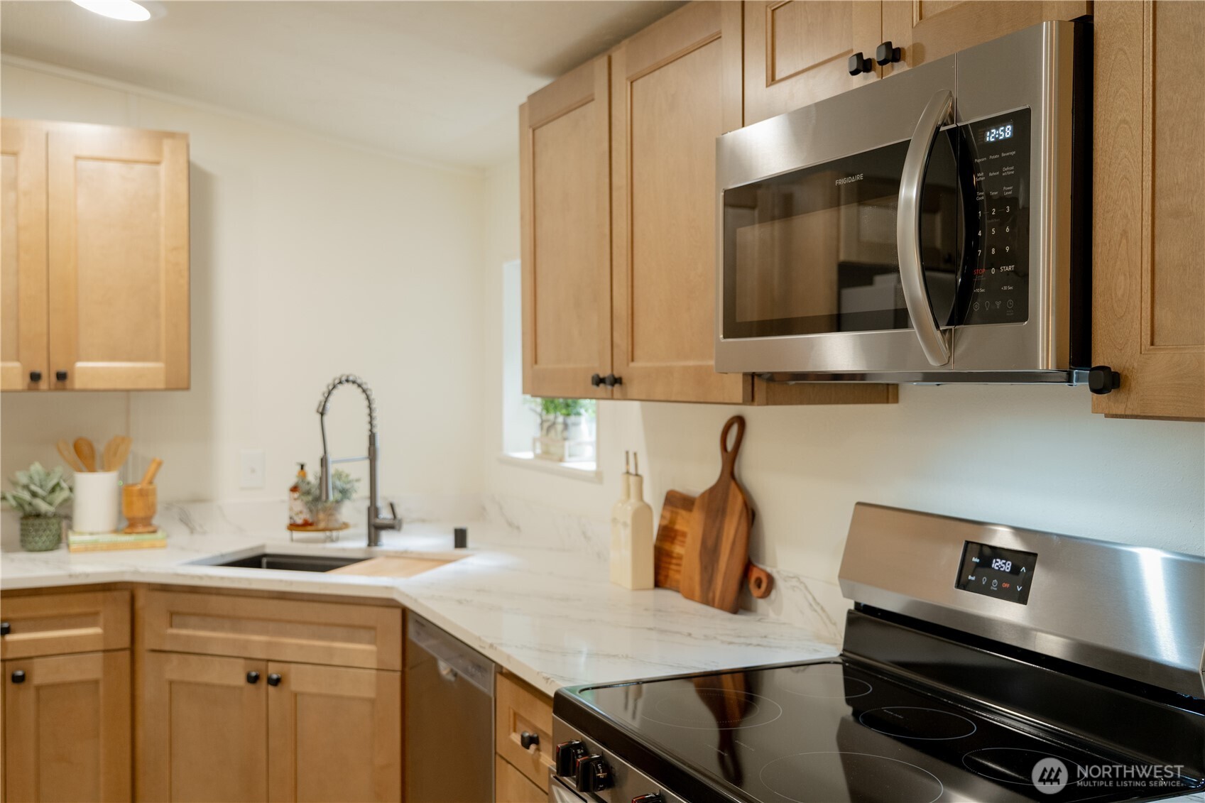 10794 Halloran Road Bow, WA 98232 - Photo 13 of 39 a kitchen with a sink cabinets and stainless steel appliances