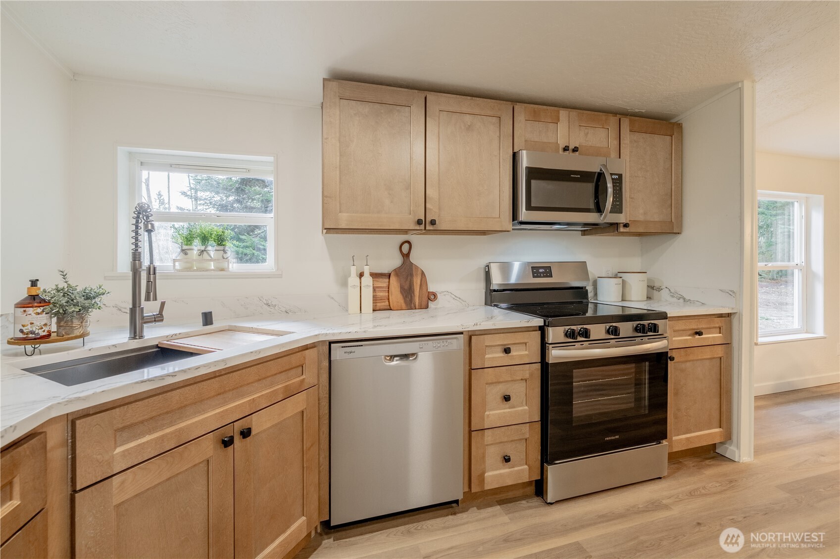 10794 Halloran Road Bow, WA 98232 - Photo 14 of 39 a kitchen with stainless steel appliances granite countertop white cabinets a sink and a stove