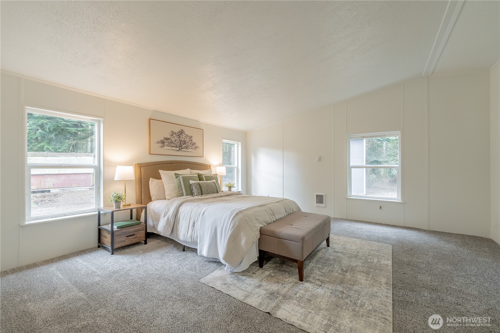 10794 Halloran Road Bow, WA 98232 - Photo 19 of 39 a spacious bedroom with a bed and a window