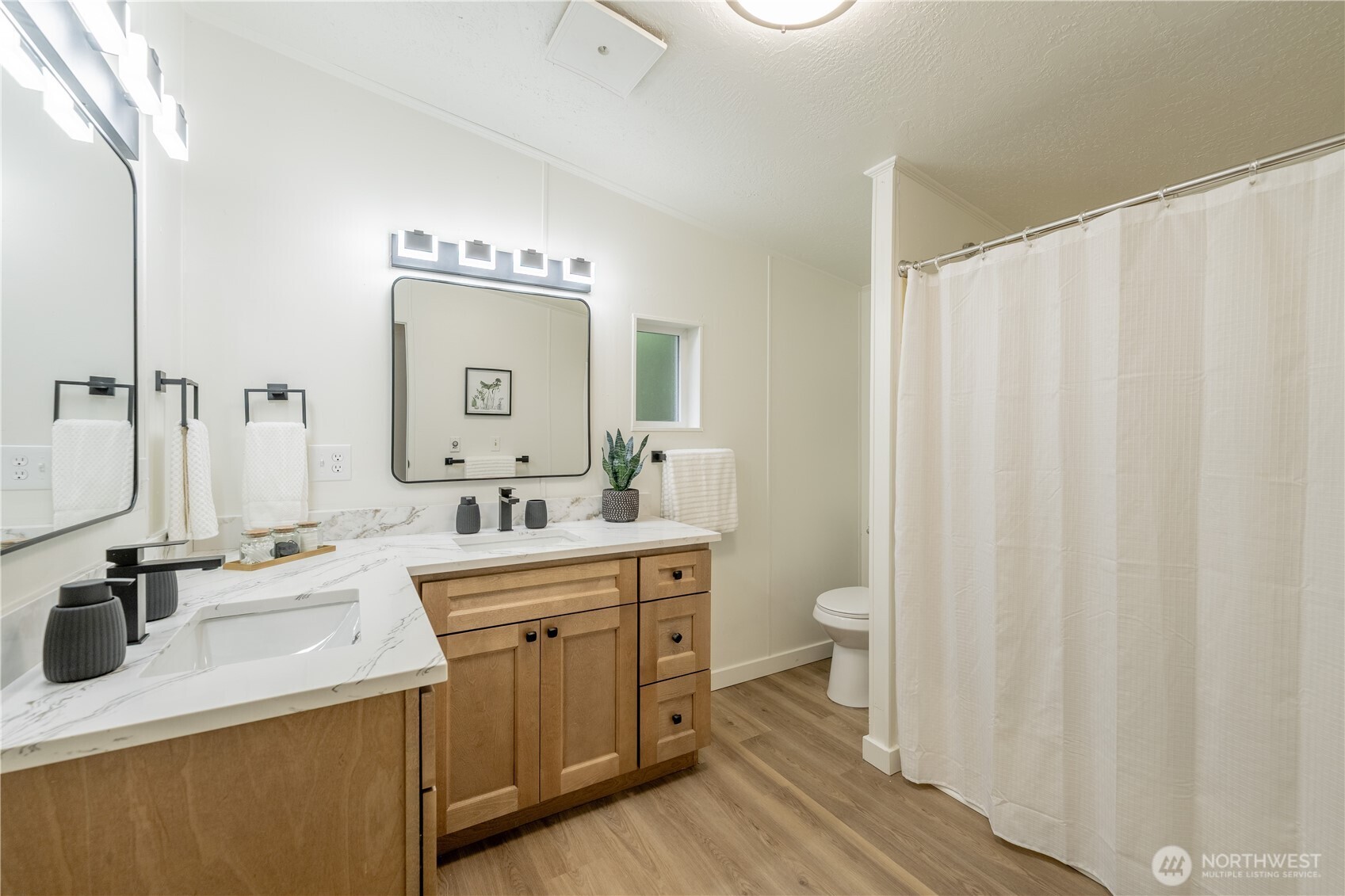 10794 Halloran Road Bow, WA 98232 - Photo 25 of 39 a bathroom with a double vanity sink mirror and toilet