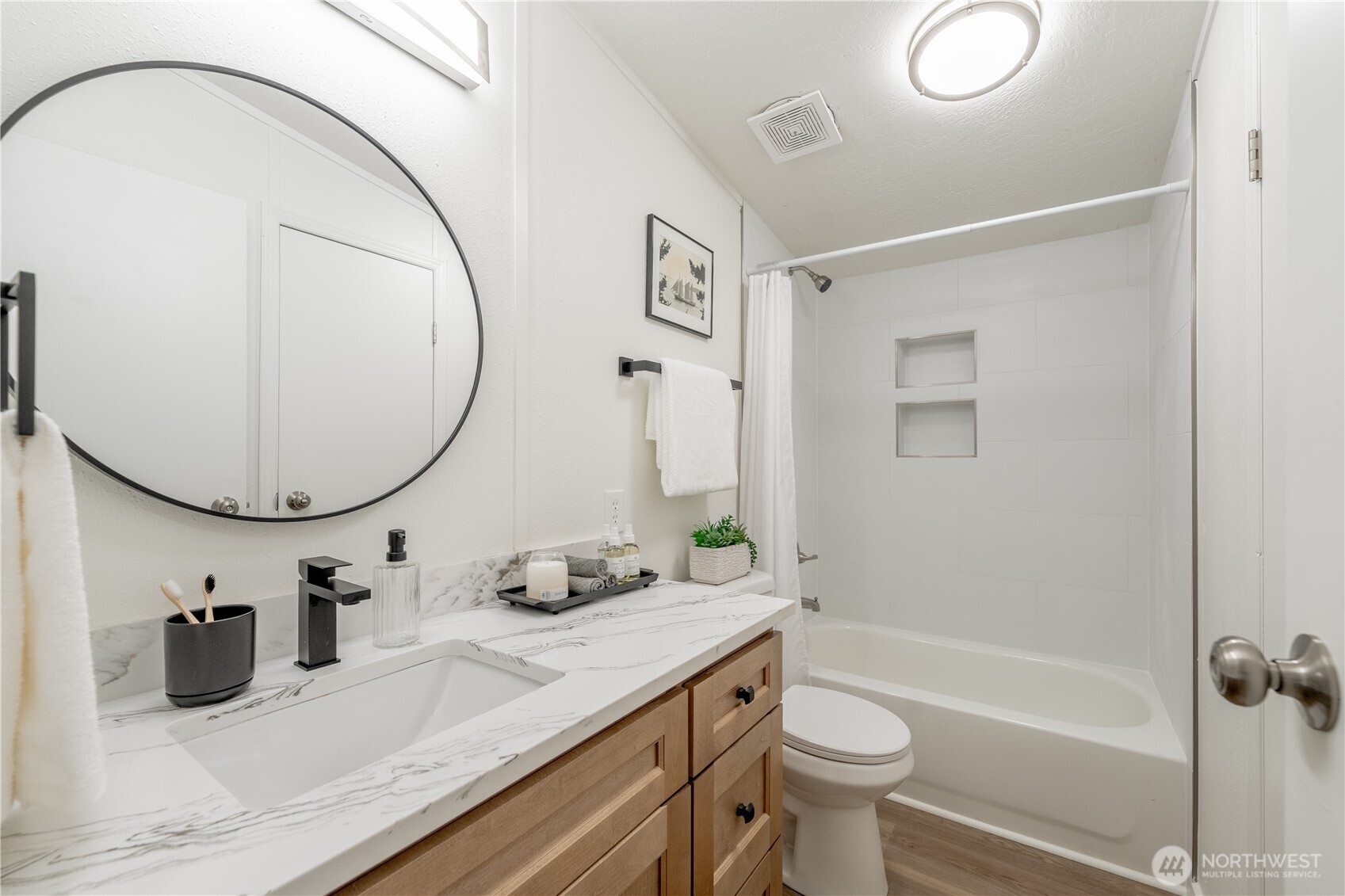 10794 Halloran Road Bow, WA 98232 - Photo 31 of 39 a bathroom with a granite countertop sink a toilet a mirror and shower